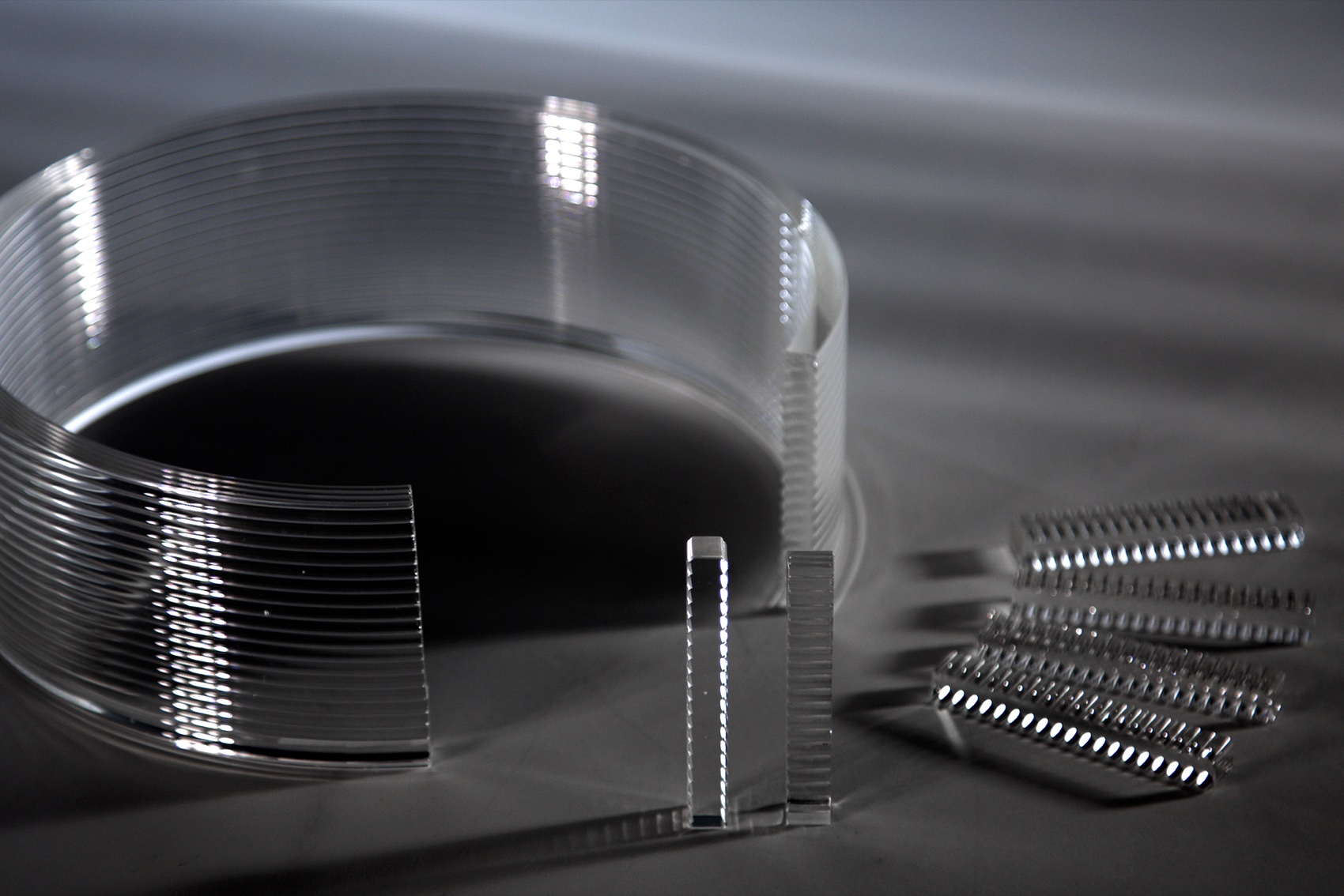 A printed glass ring beside small mechanical test coupons